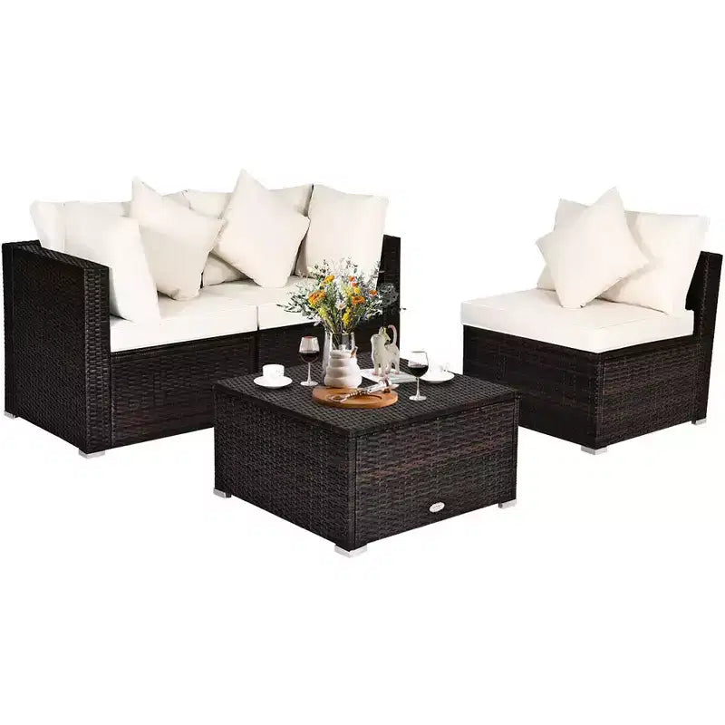 Set di mobili da giardino Costway in rattan composto da 4 pezzi, divano con cuscini e pouf